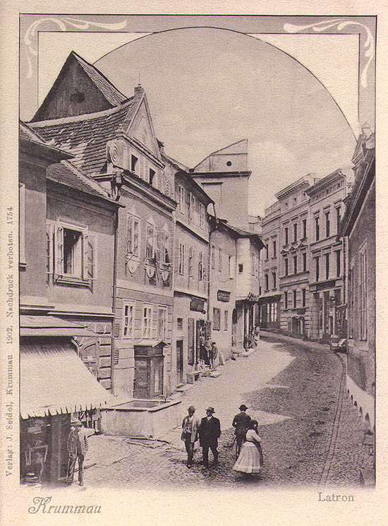 View onto lower part of Latrán Street in Český Krumlov, fountain in the foreground, historical photo