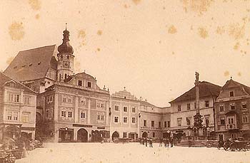 Square in Český Krumlov, in the background is Church of St. Vitus with Baroque tower from 1893 , historical photo 